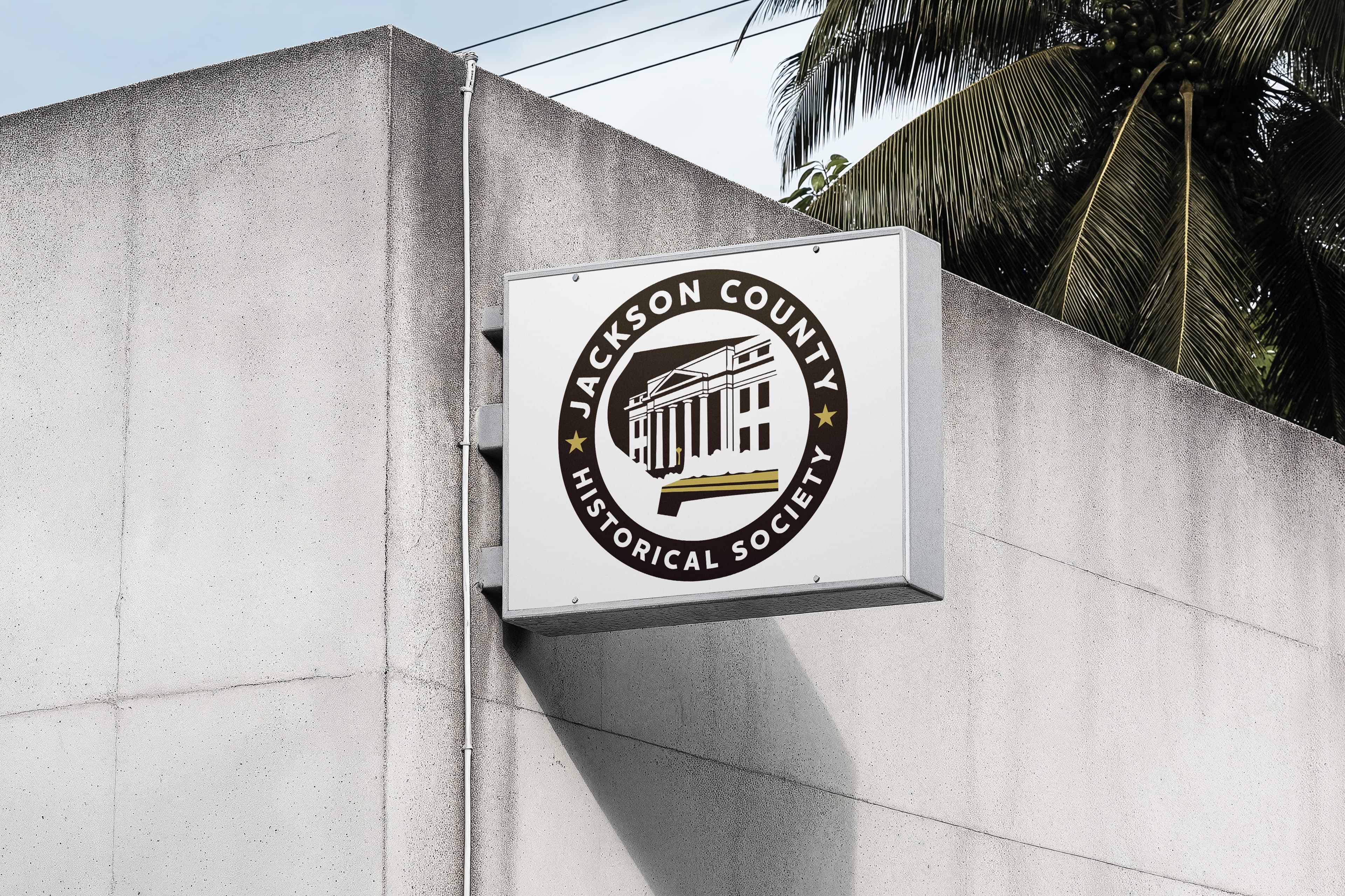 Jackson County Historical Society branding concept shown on a concrete wall mockup