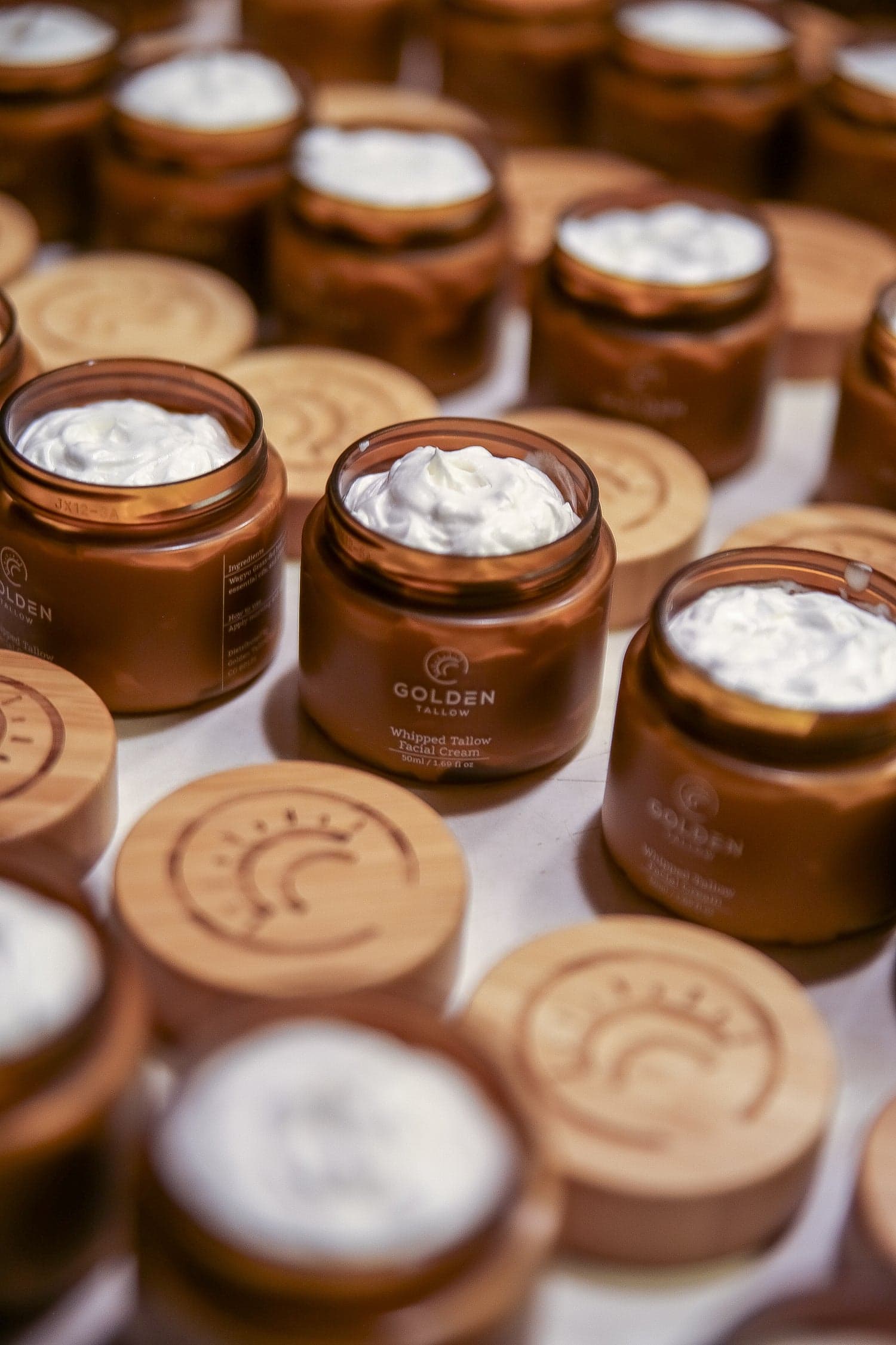 Golden Tallow product jars photographed together for brand and packaging presentation