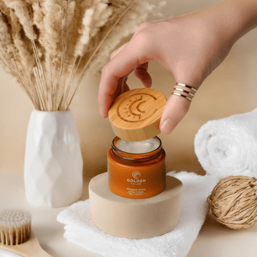 Golden Tallow jar held in hand as part of branded product photography