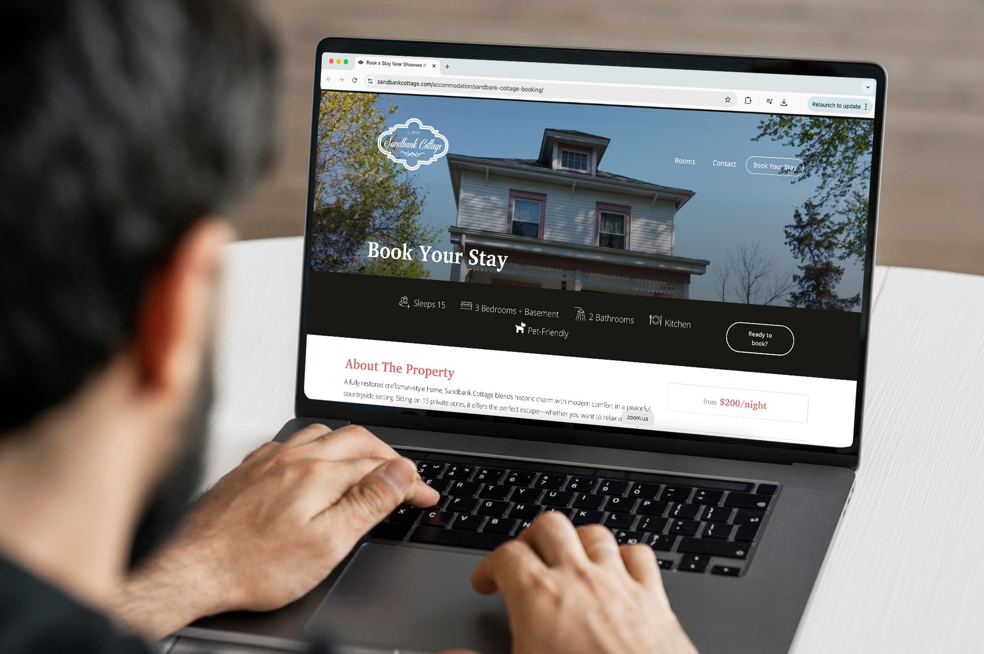 Sandbank Cottage website mockup on laptop