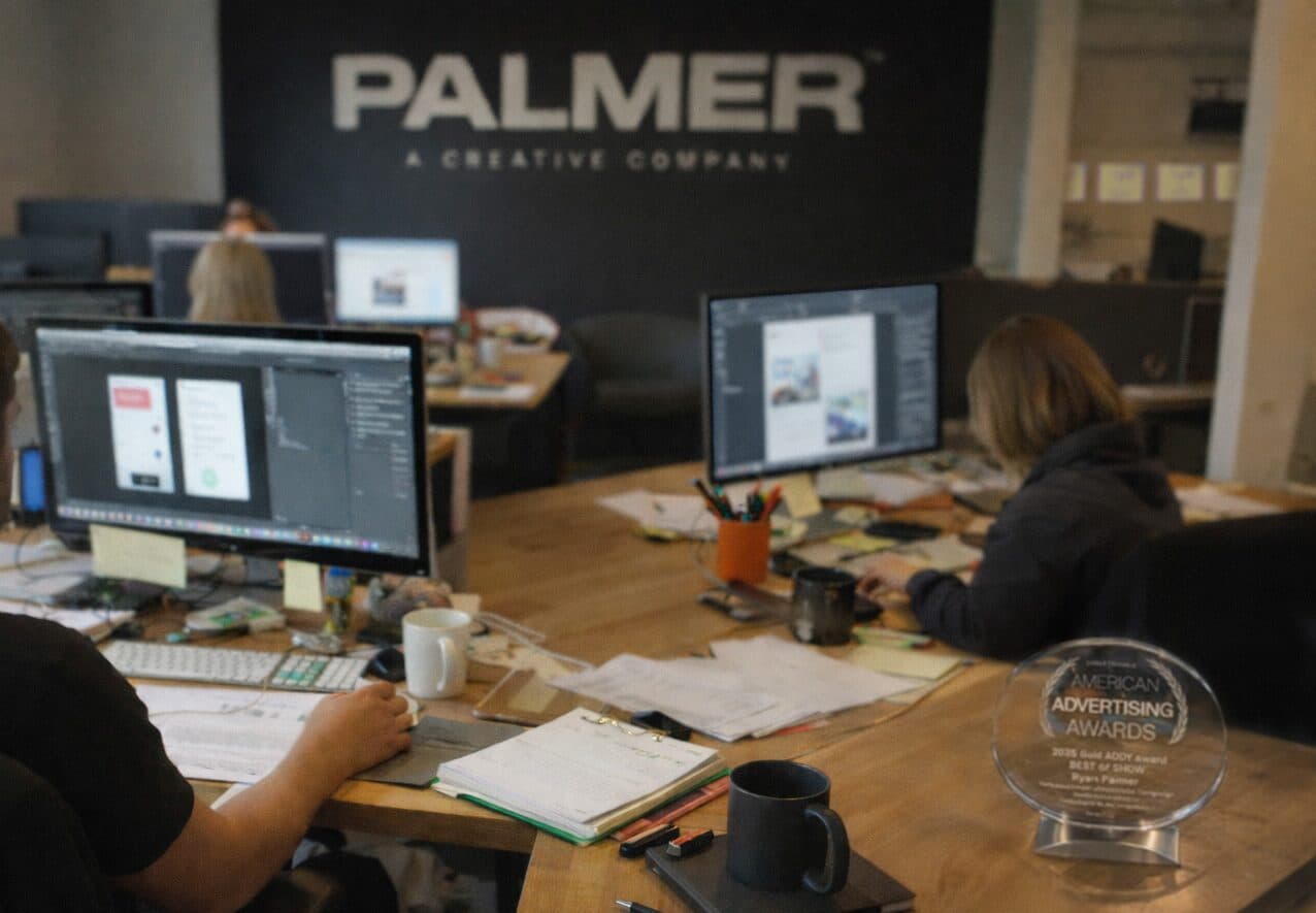 Designers at work in the Palmer studio beside an ADDY award