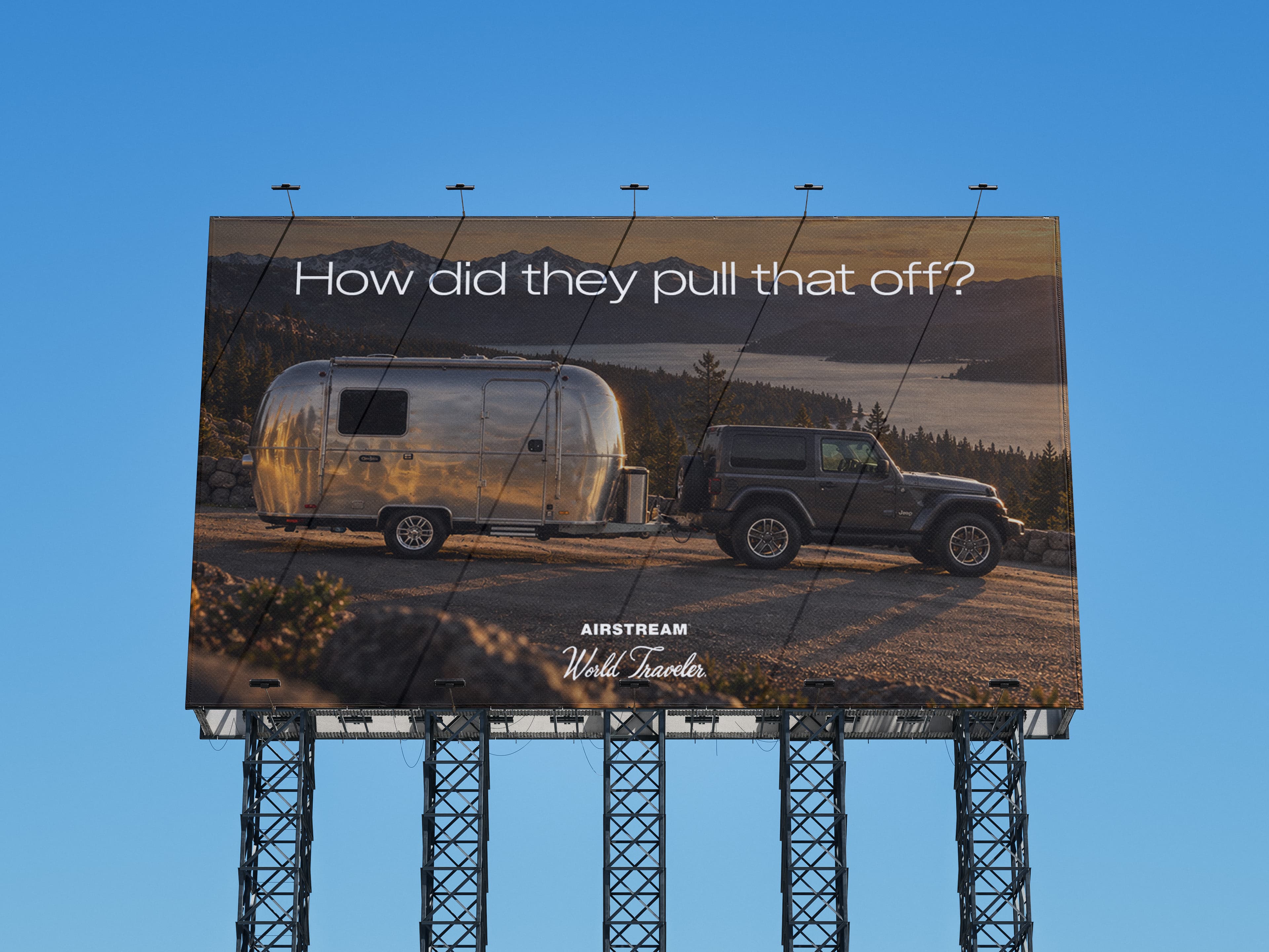 Airstream World Traveler billboard advertising concept overlooking a mountain lake