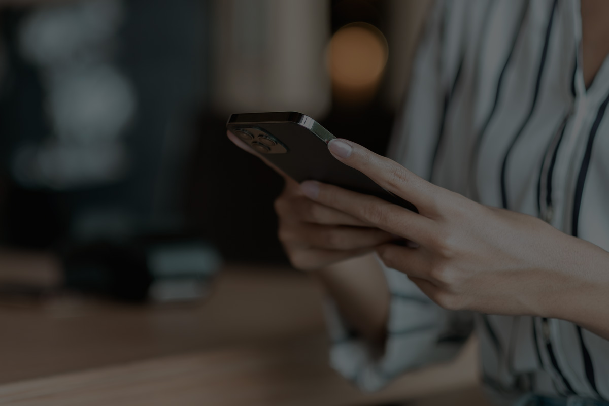 woman holding phone spending time on social media